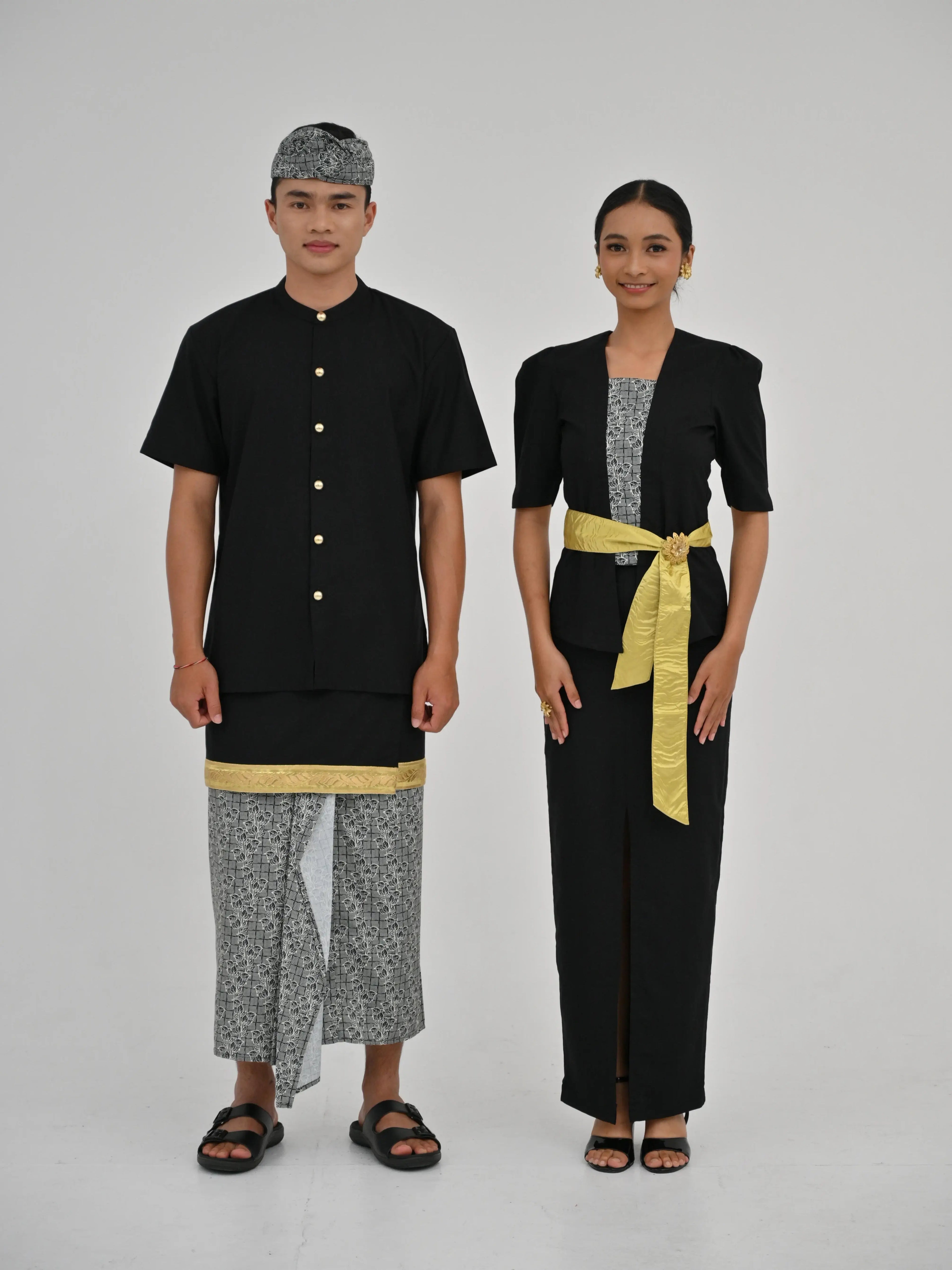 Two people wearing traditional black and gray outfits with yellow accents on a white background